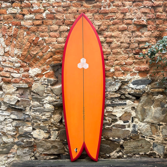 Front view of CHANNEL ISLANDS   FEB'S FISH   in orange red  leaning against a wall.