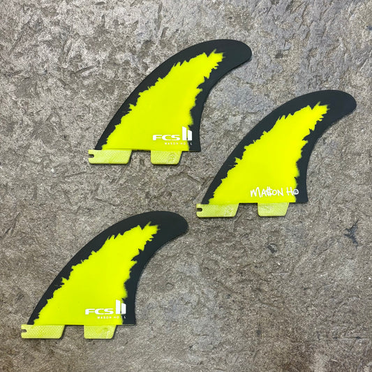 FCS II Mason Ho Signature Fin - Full thruster lying on concrete floor - Bright Yellow and Black