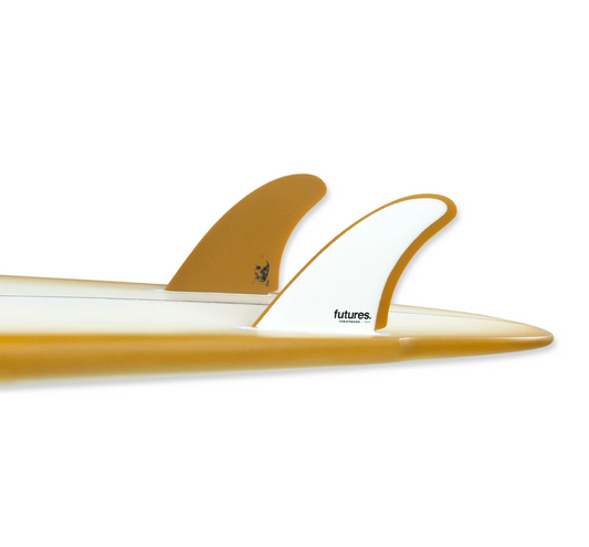 A pair of futures The Christenson Twin fins, one with white and the other with a yellow color scheme, displayed in a surfboard.