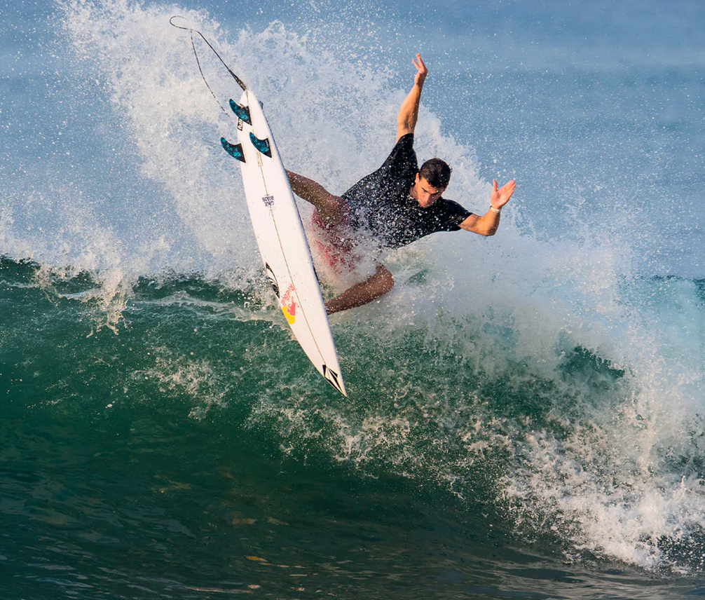 Jack Robinson surfing, doing an aerial while using his signature future fins.