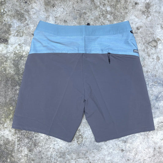 Blue shorts with a brand tag on a concrete surface Blue shorts with a brand tag on a concrete surface