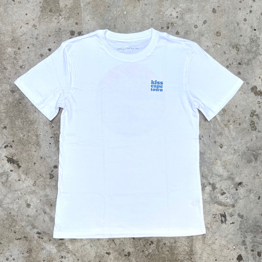 White t-shirt with blue text on a concrete surface