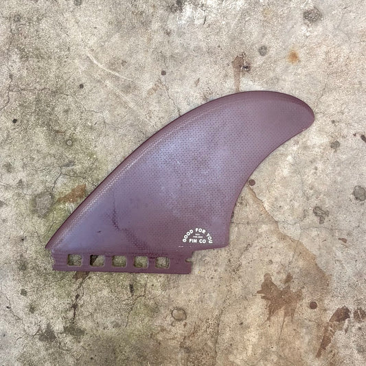 Purple surf fin on a concrete surface