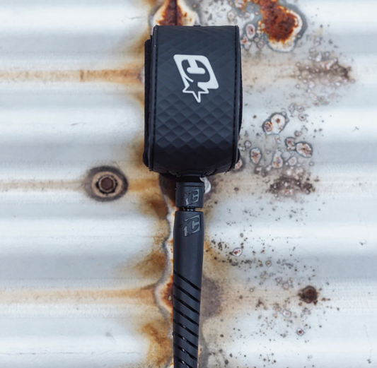 Black strap with a logo on a rusty metal surface