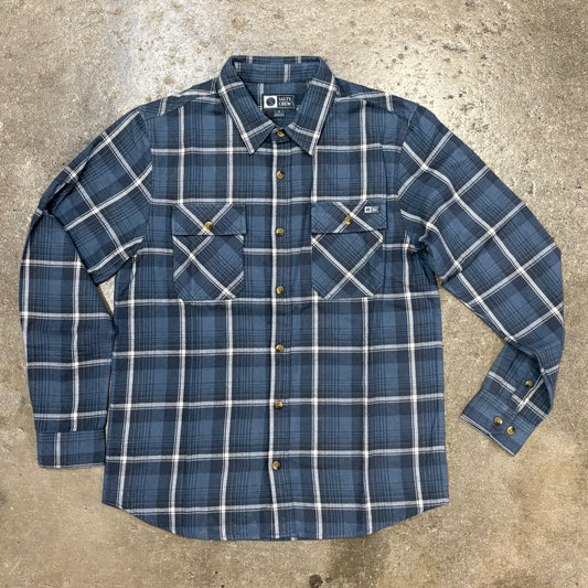 Front view of blue plaid long sleeve shirt on concert floor