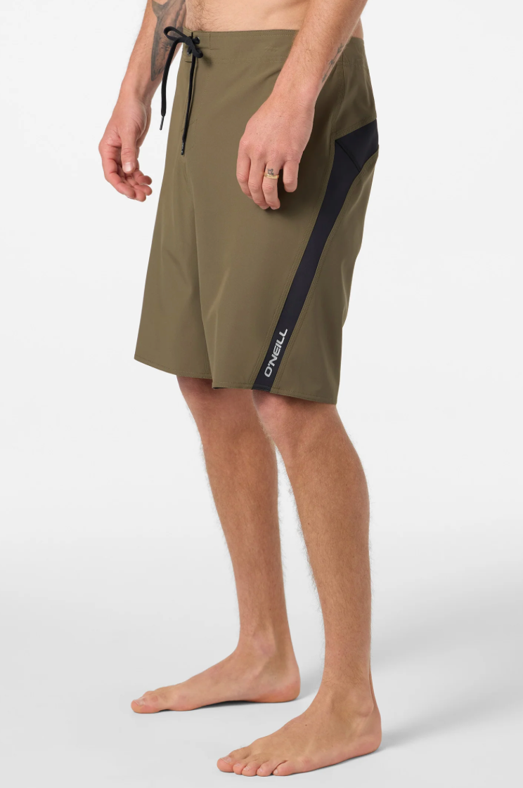 Person wearing olive green shorts with black accents on a white background
