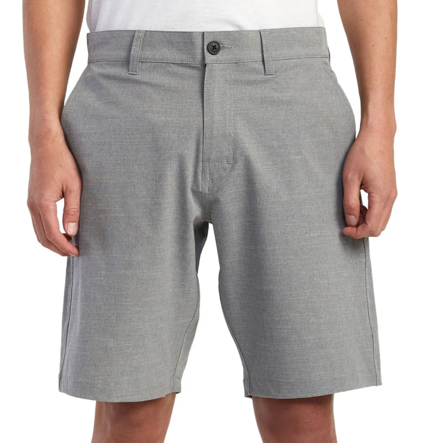 Gray shorts worn by a person on a white background