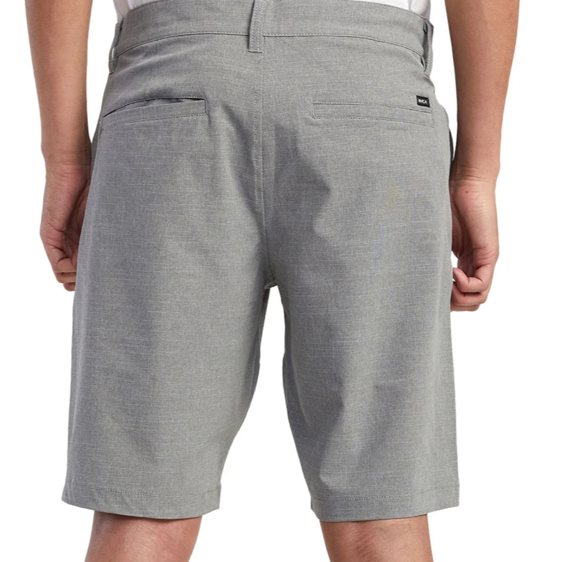 Gray shorts worn by a person on a white background