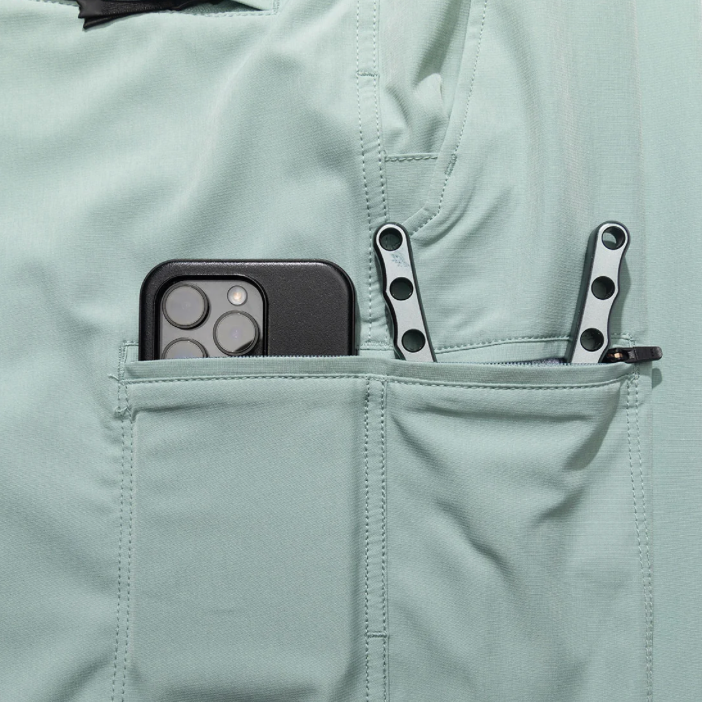 Light gray pants with a pocket containing a phone and keys.