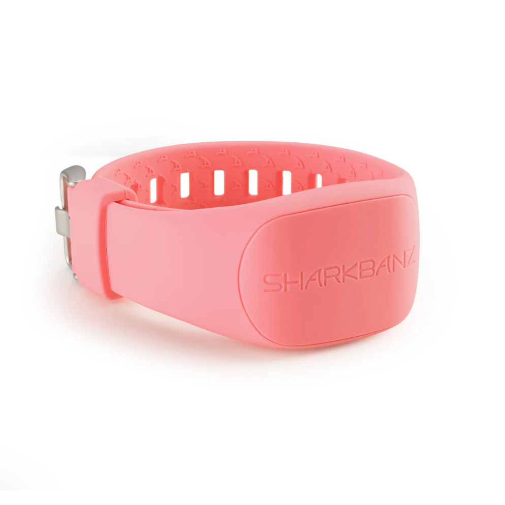 Pink shark repellent band with 'SharkBanz' branding on a white background