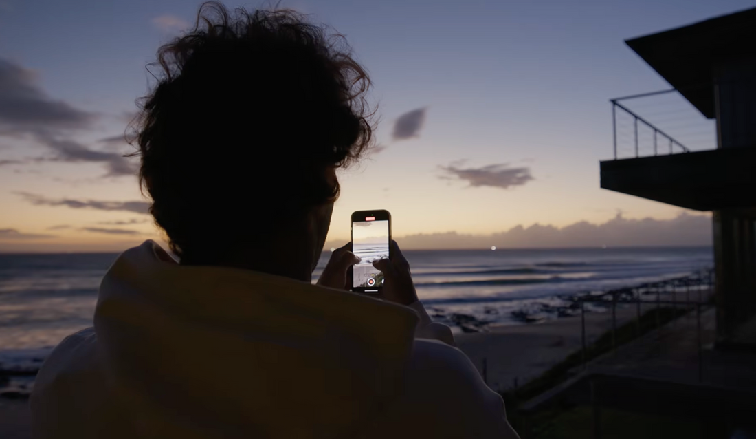 Jordy Smith taking a picture on a cellphone from the waves at Jeffreys Bay
