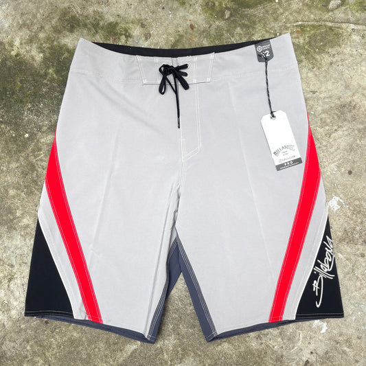 Billabong retro short in grey, red and black on concrete floor