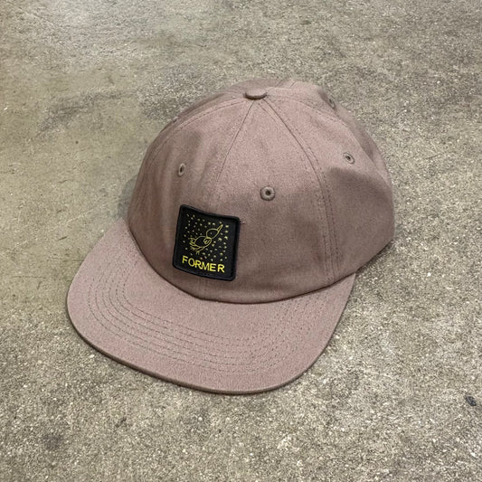 Brown cap with a patch on a concrete surface