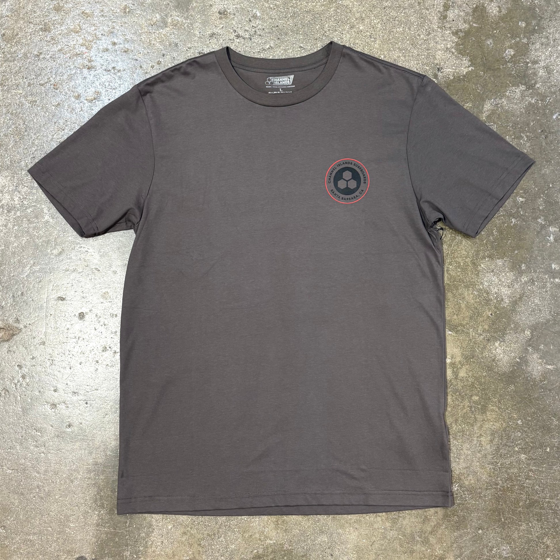 Brown CHANNEL ISLANDS   CIRCLE CHAIN SS TEE on a concrete surface