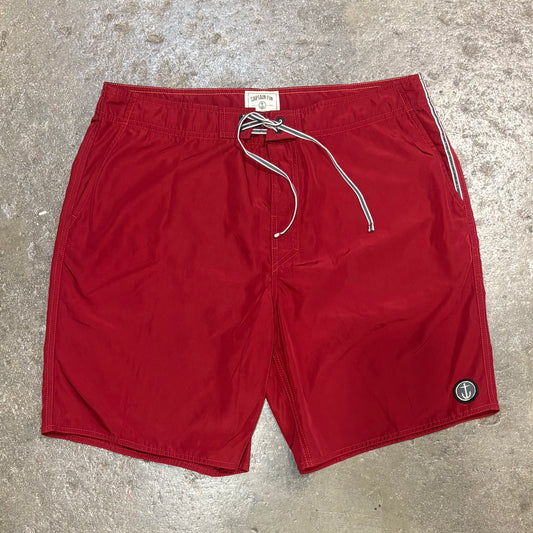 Red shorts with a drawstring on a concrete surface