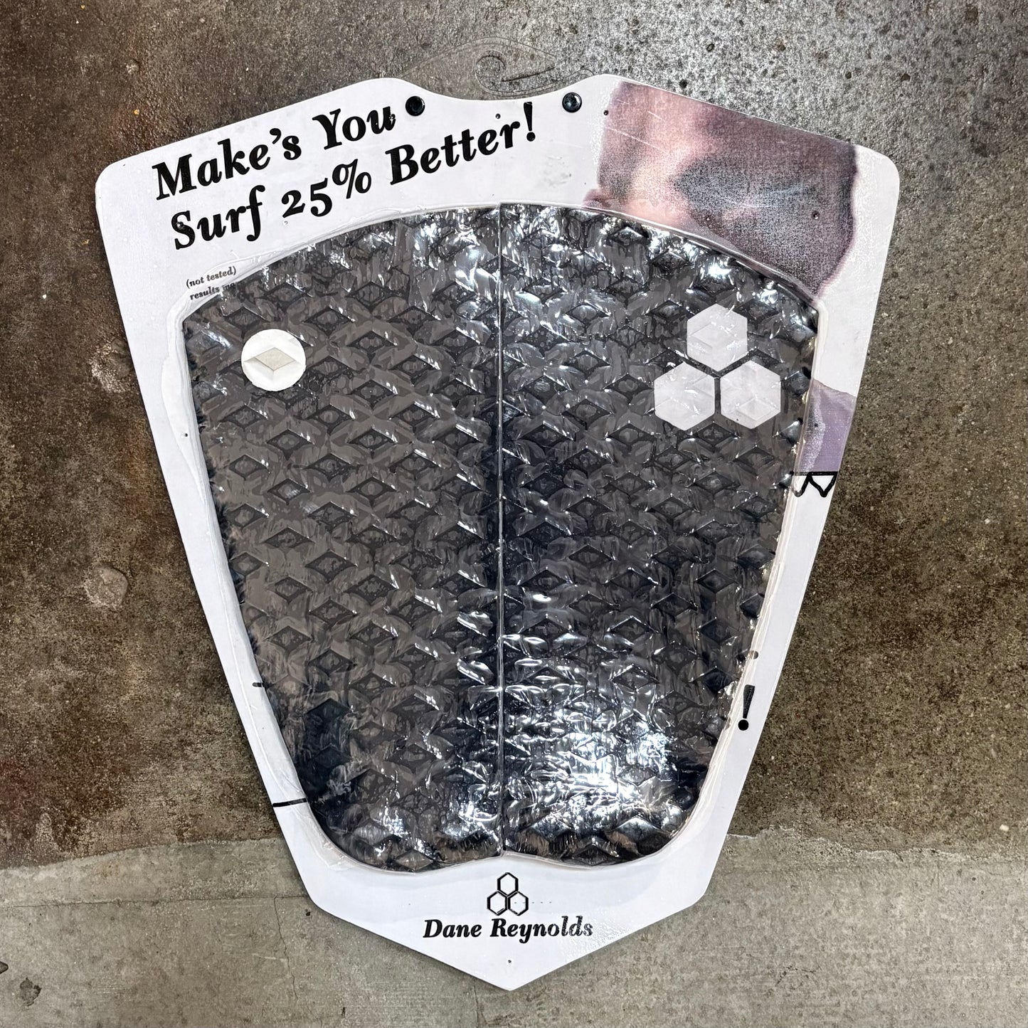 Dane Reynolds surf pad with text on a textured surface
