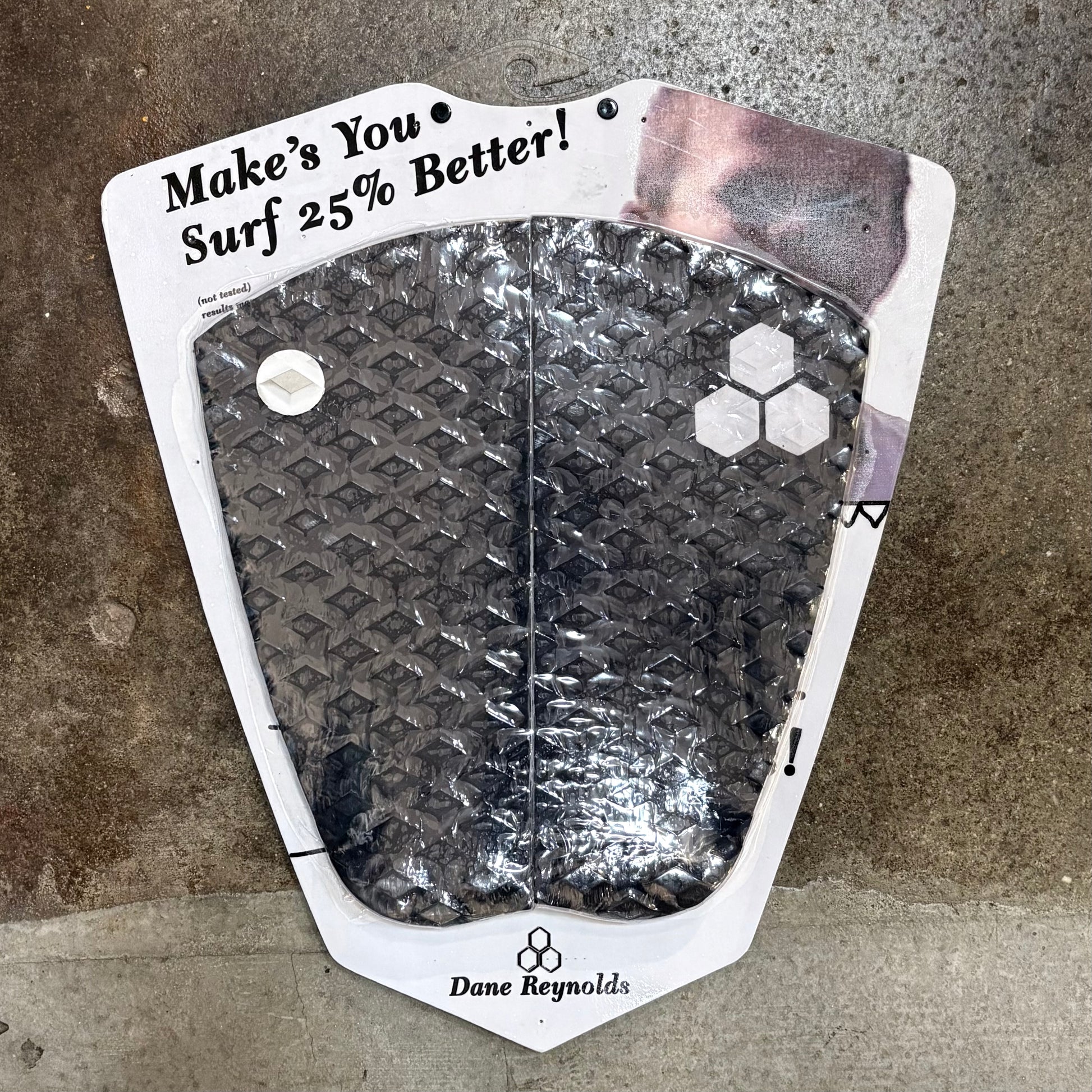 Dane Reynolds surf pad with text on a textured surface