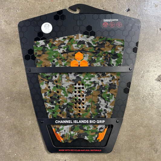 Camouflage-patterned grip pad with branding on a concrete surface