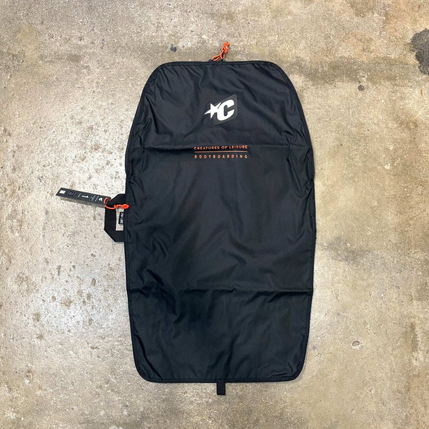 Black bag with a logo on a concrete surface