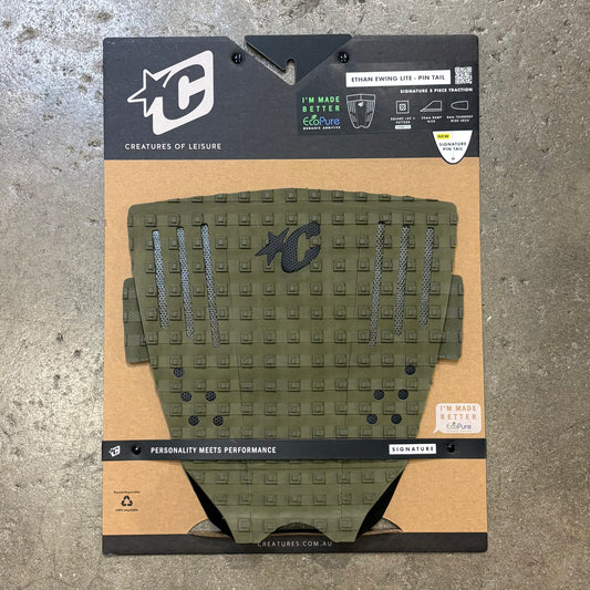 Green textured pad with brand logo on a cardboard backing against a concrete background