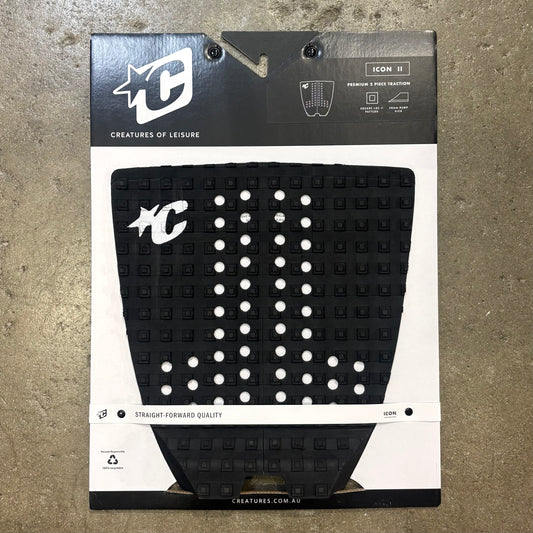 Black and white textured pad with brand logo on packaging against a brown background