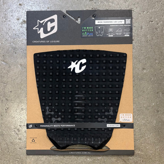 Black textured pad on a branded packaging with visible logos on a concrete surface