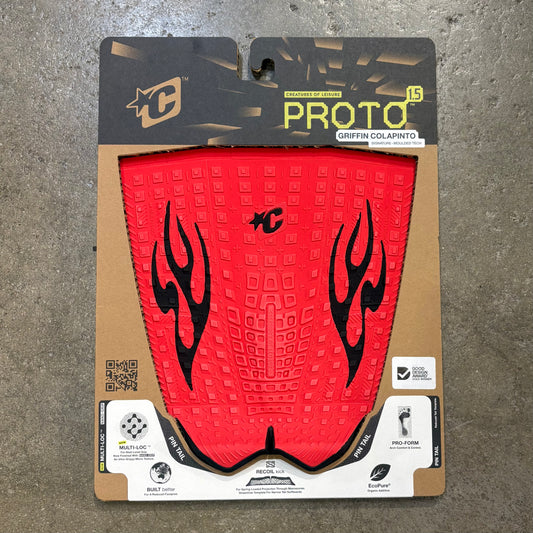 Red motorcycle tank pad with black flame design in packaging on a concrete surface