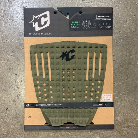 Green textured pad with brand logo on a cardboard backing, on a concrete surface