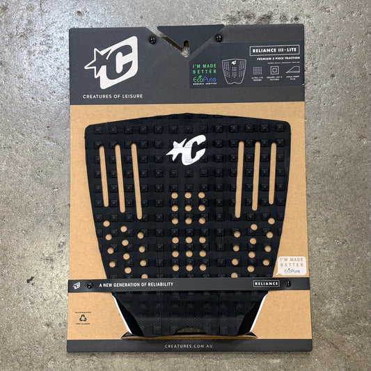 Black textured pad on a cardboard packaging with brand logos on a concrete surface