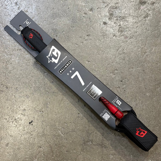 Black and red ski with packaging on a concrete surface