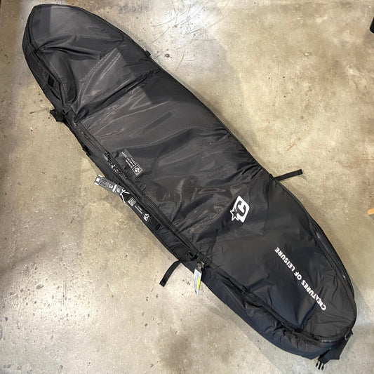 Creatures of Leisure Shortboard Triple DT2.0 Board Cover 7'1  in black on a concrete floor.