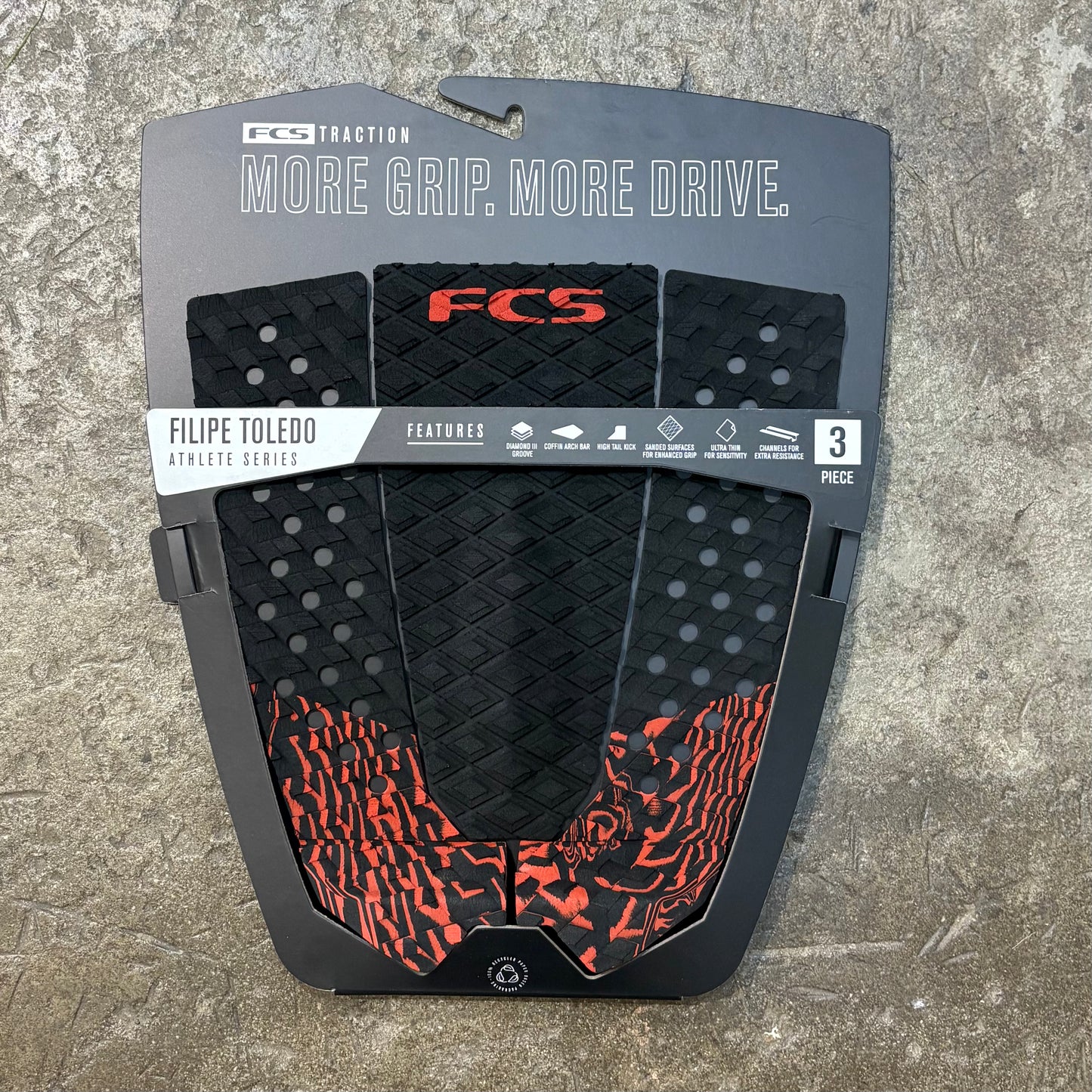 FCS surfboard traction pad packaging on a concrete surface