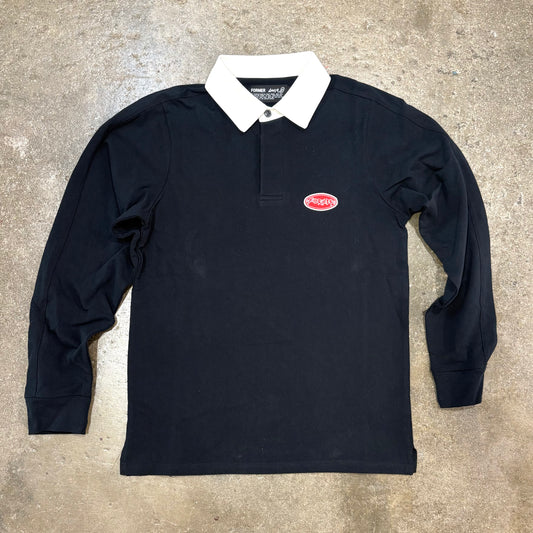 Black long-sleeve polo shirt with a red logo on a concrete surface