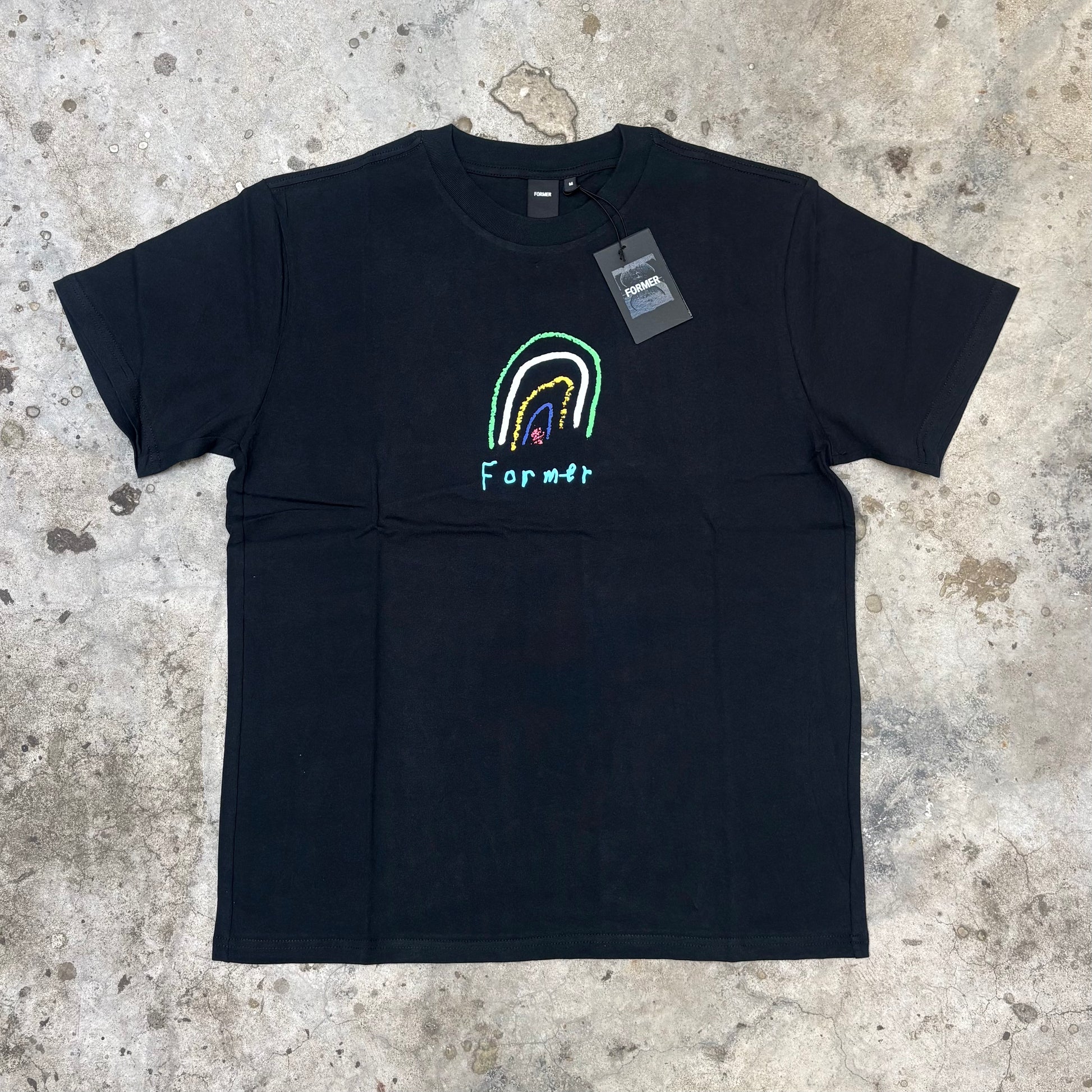 Black t-shirt with a colorful rainbow design and 'Famous' branding on a textured surface