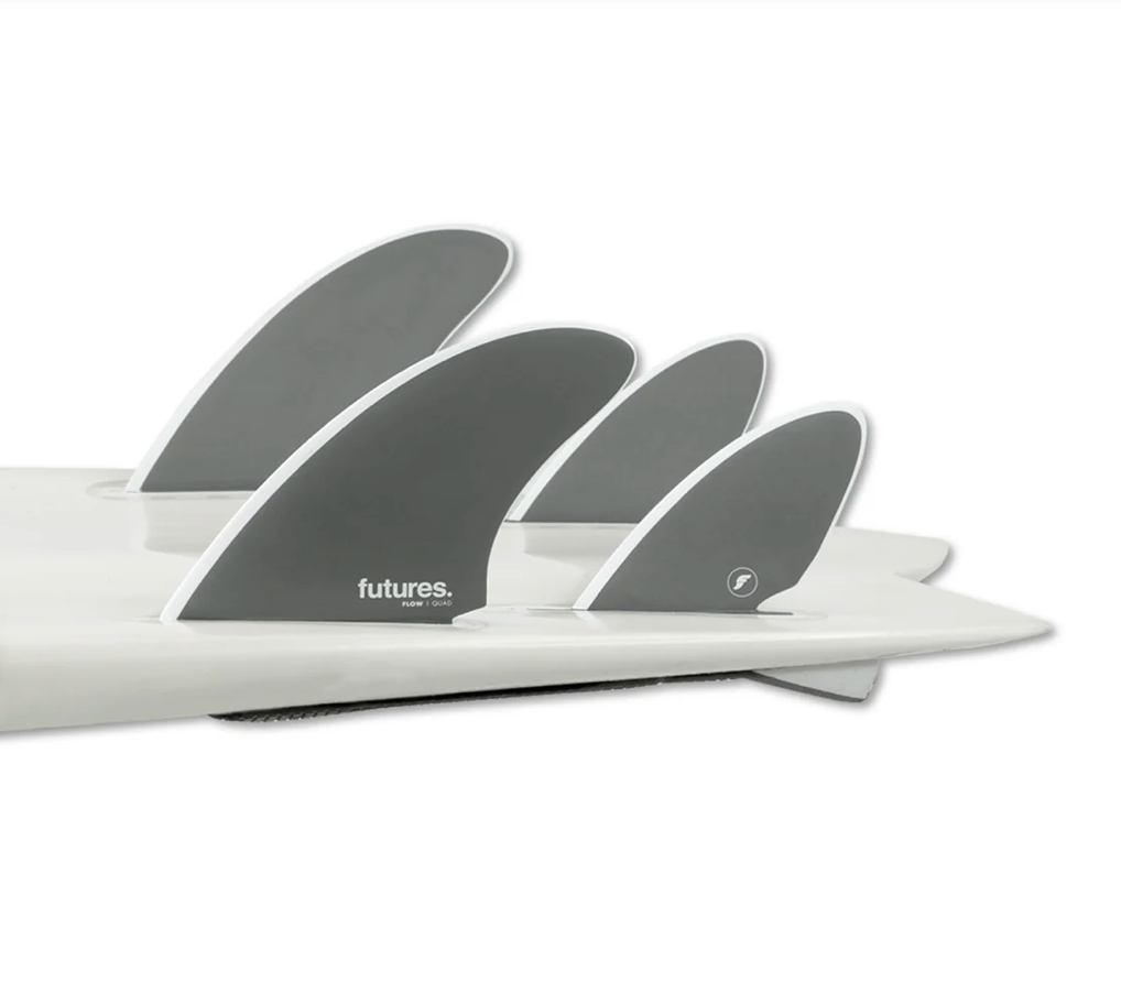 A set of Futures Flow Quad Surfboard finsin a grey colour way in a white surf board.