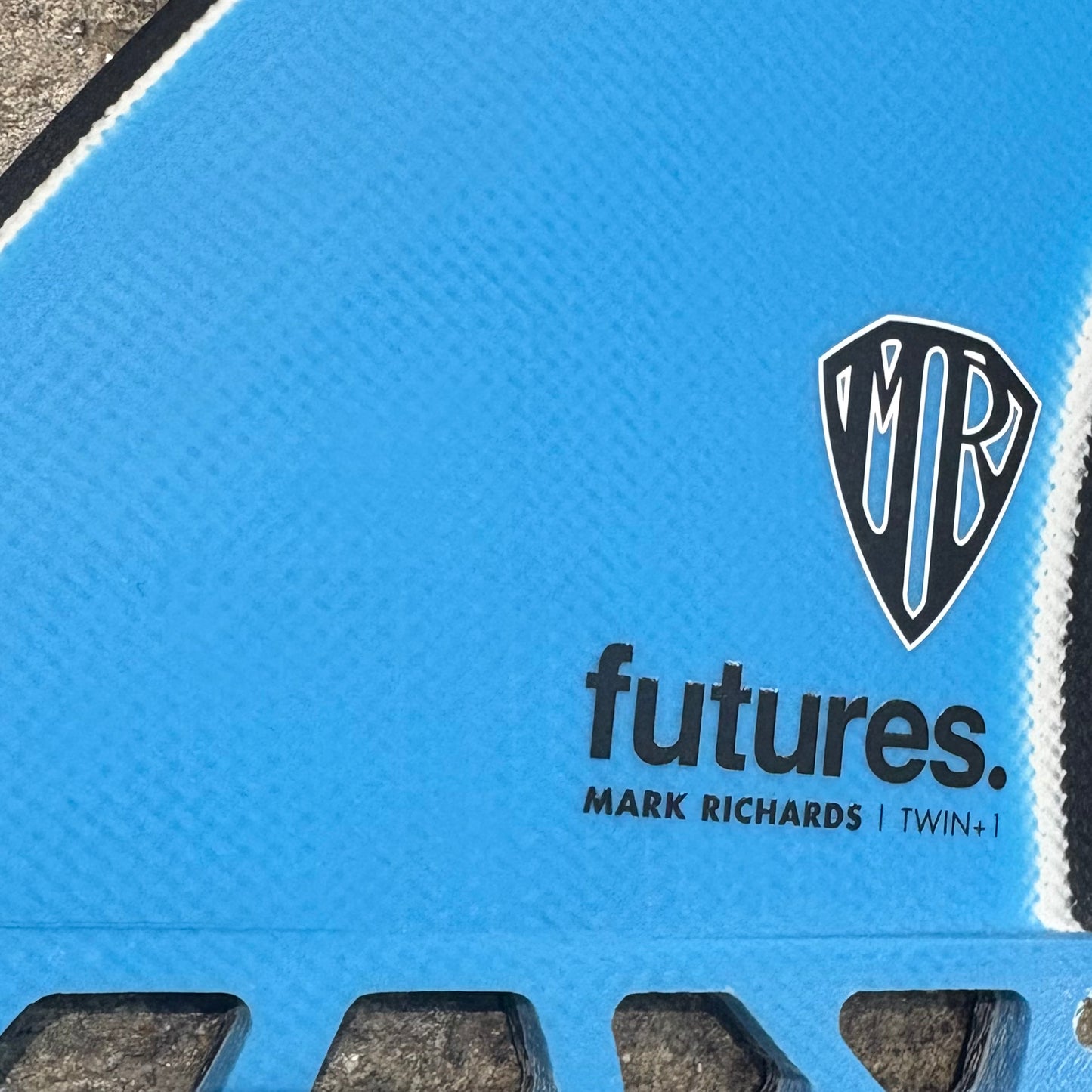 Blue set of Futures Mark Richards Twin+1 with 'futures' and 'Mark Richards' branding on a fiberglass construction.
