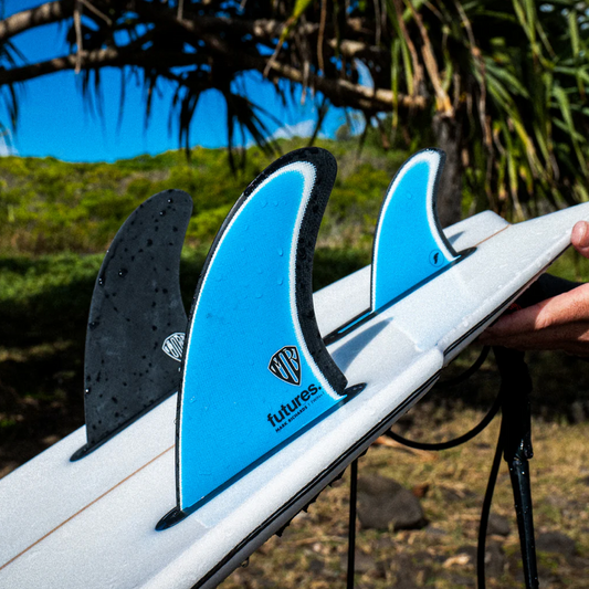 Surfboard with blue Futures Mark Richards Twin+1 fins outdoors