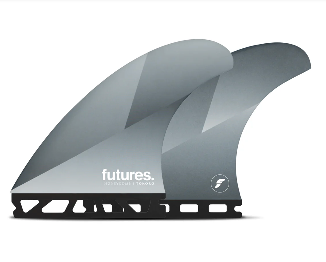 A set of Futures Tokoro silver surfboard fins in a honeycomb construction, against a white background.
