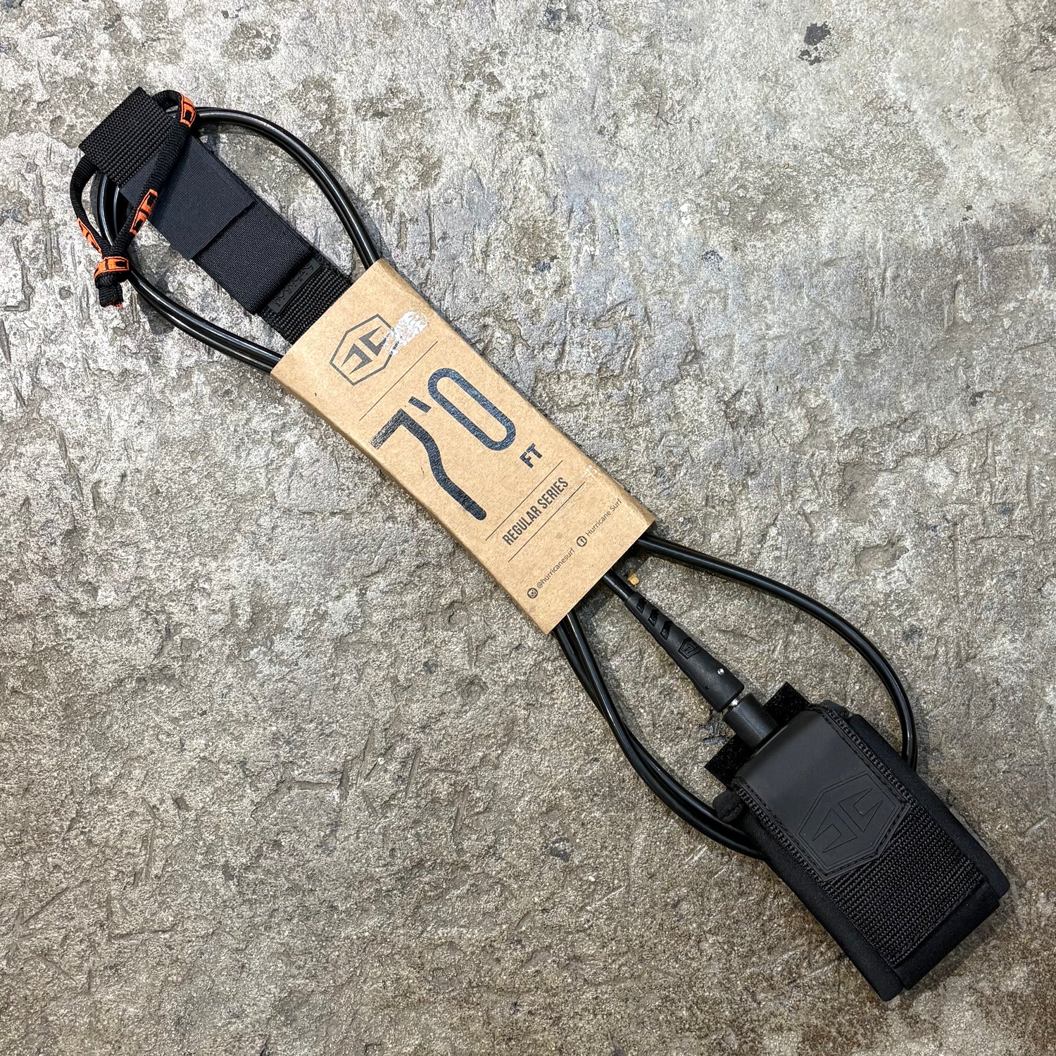 Black Hurricane leash with a cardboard label on a textured gray surface