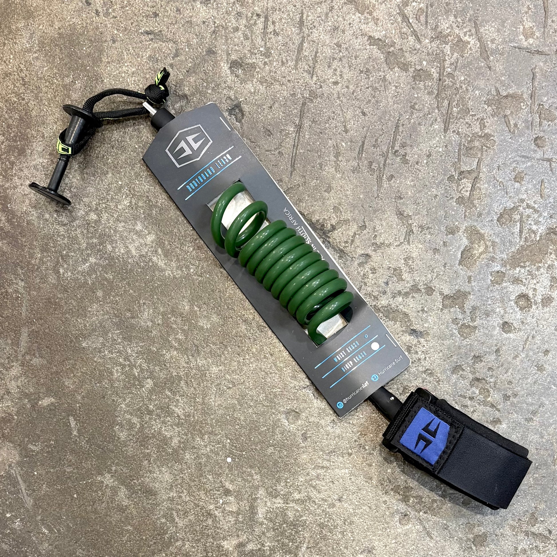 Green HURRICANE   BODYBOARDING COILED WRIST LEASH 8MM in Packaging on concrete floor
