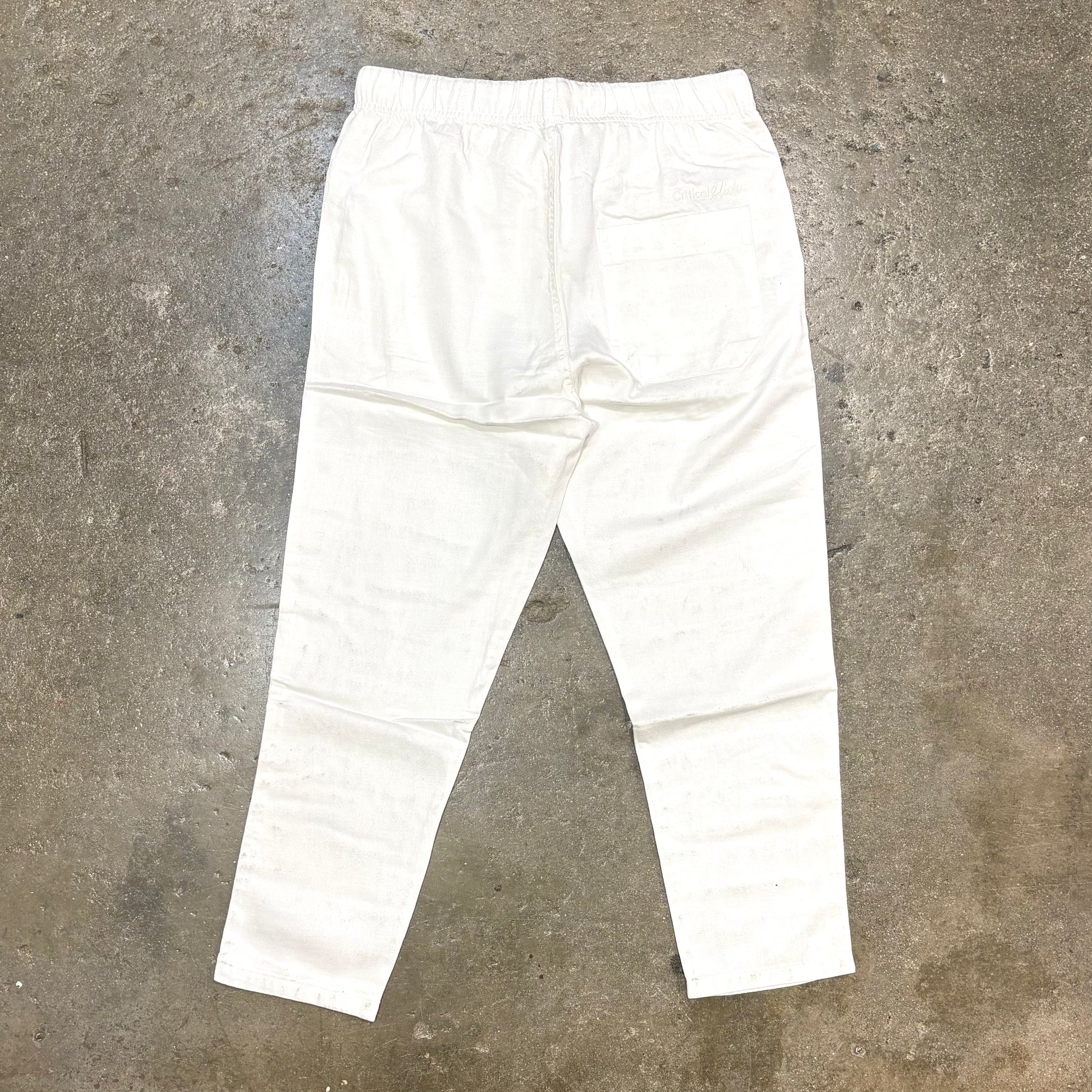 White pants on a textured gray surface