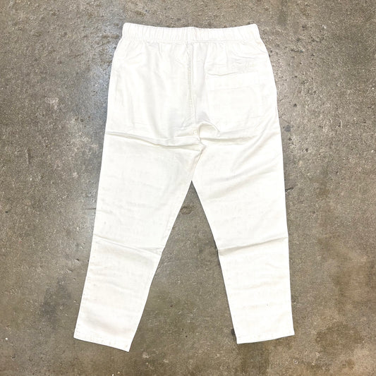White pants on a textured gray surface