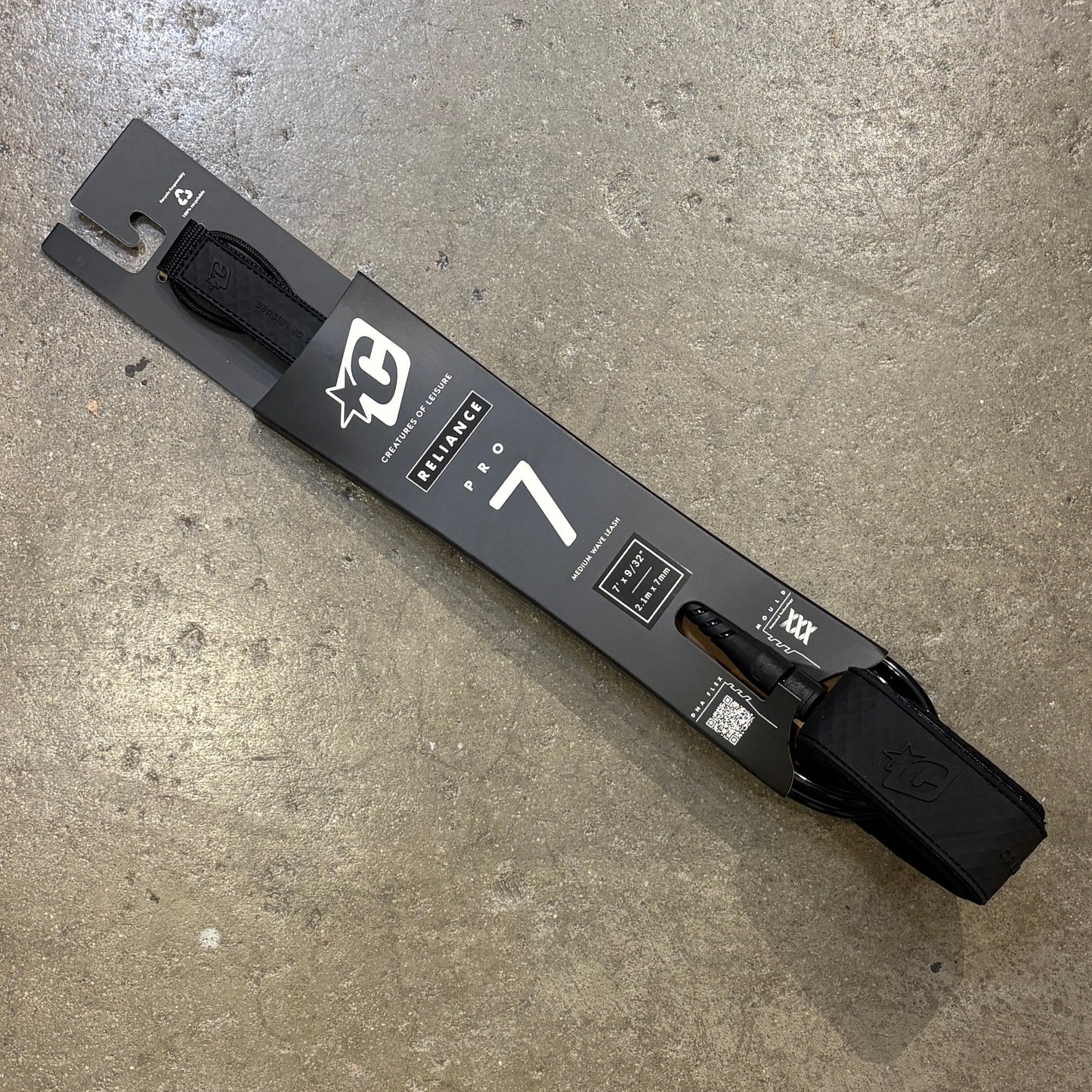 Black surf leash on a concrete surface