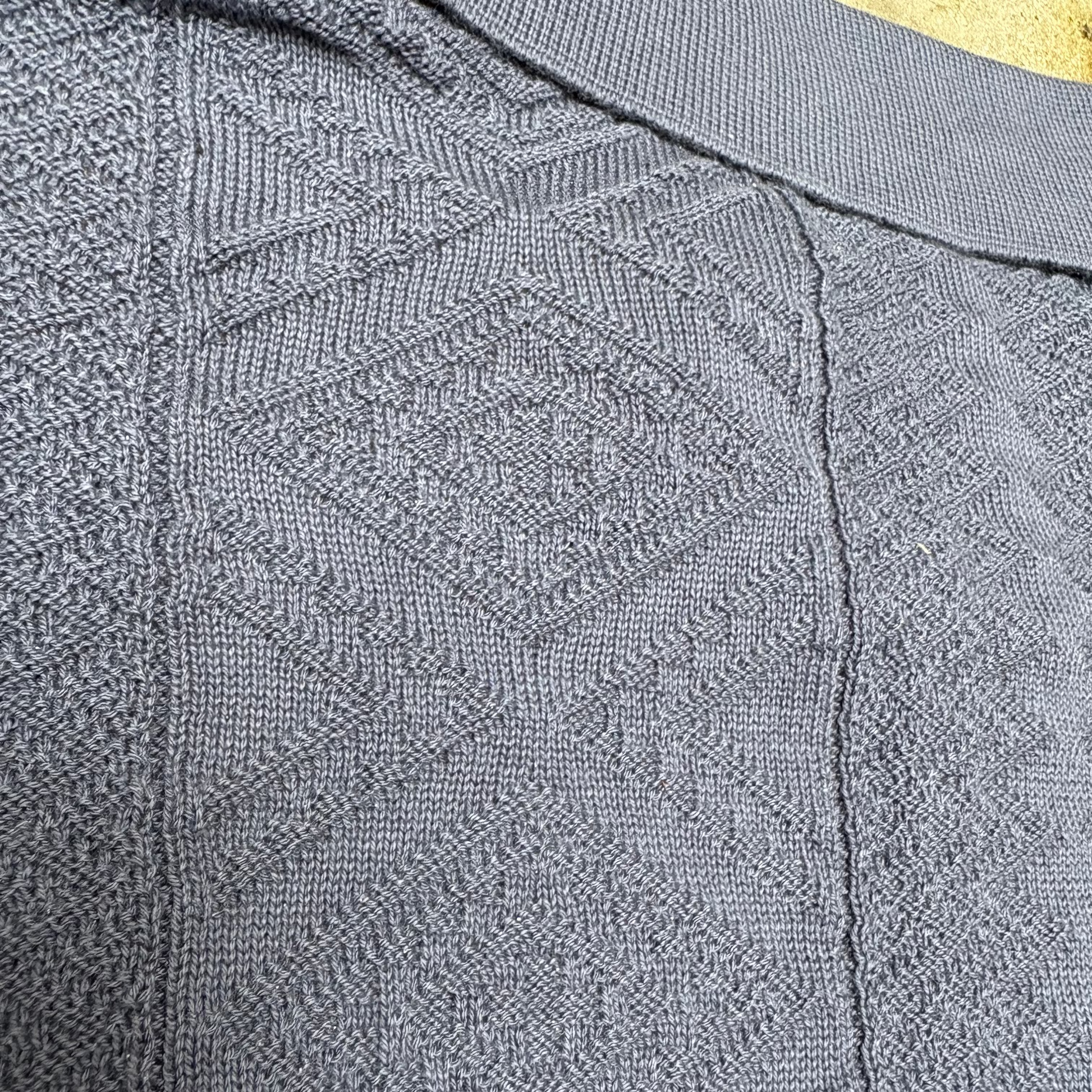 Close-up of a textured gray fabric with a subtle pattern