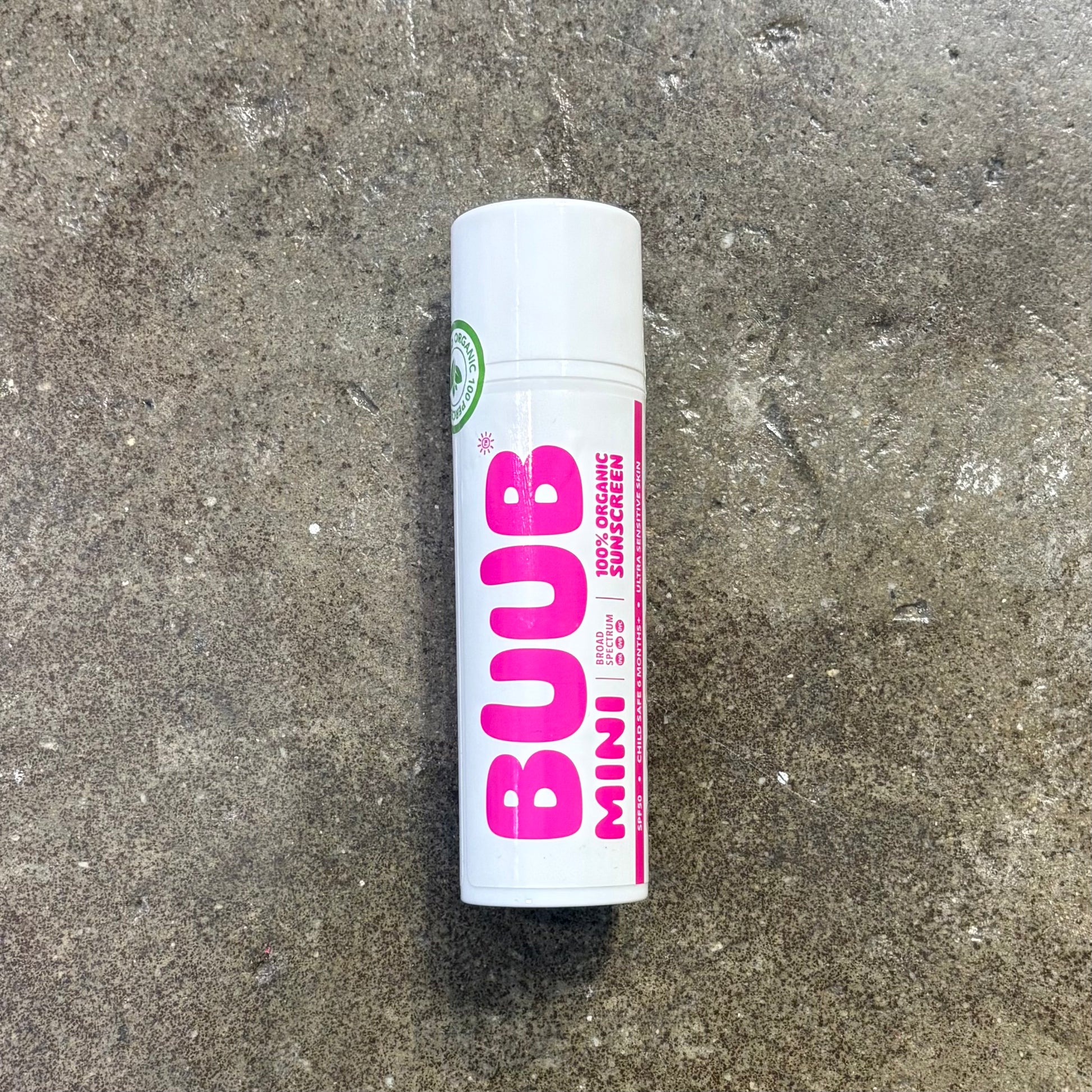BUUB Mini sunscreen tube on a concrete surface