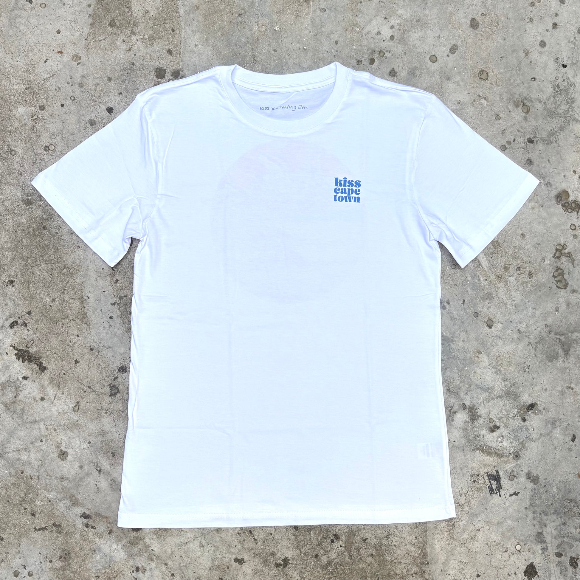 White t-shirt with blue text on a concrete surface