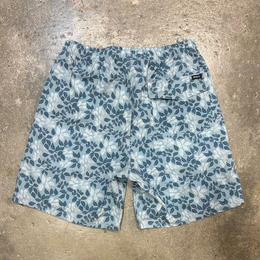 Blue floral-patterned shorts on a concrete surface