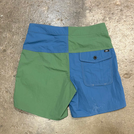 Green and blue shorts on a concrete surface
