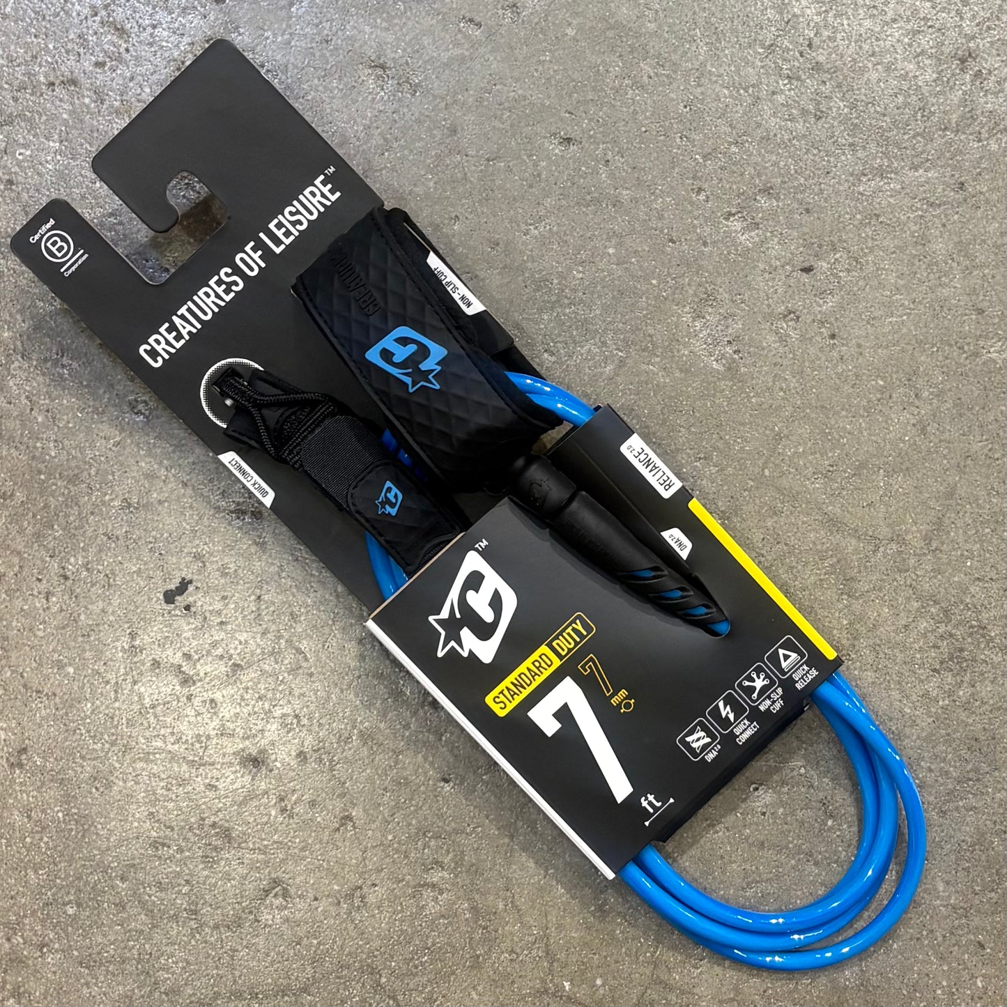 Blue leash with packaging on a concrete surface