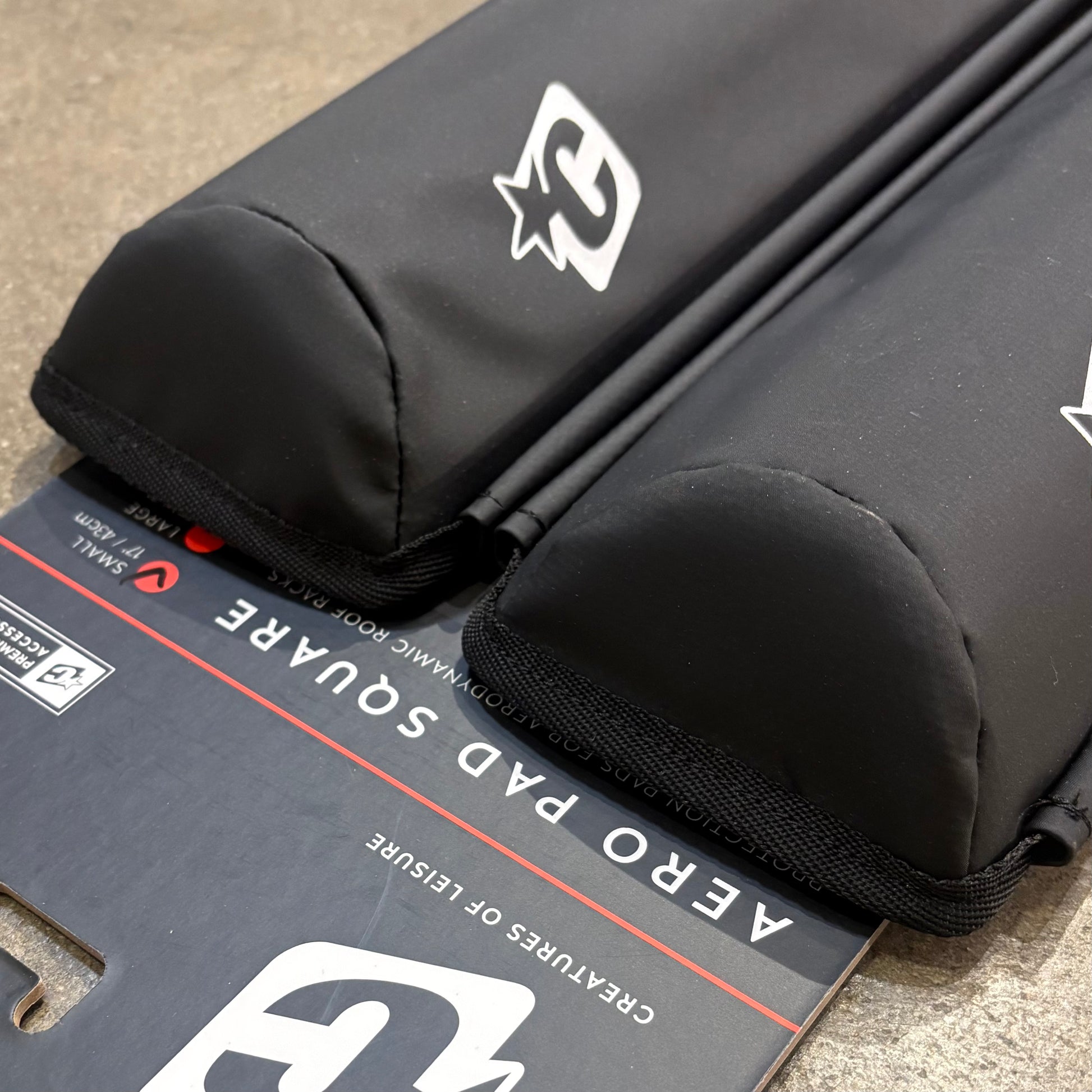 Black protective pad with a brand logo on a cardboard box labeled 'Aero Pad Square'.
